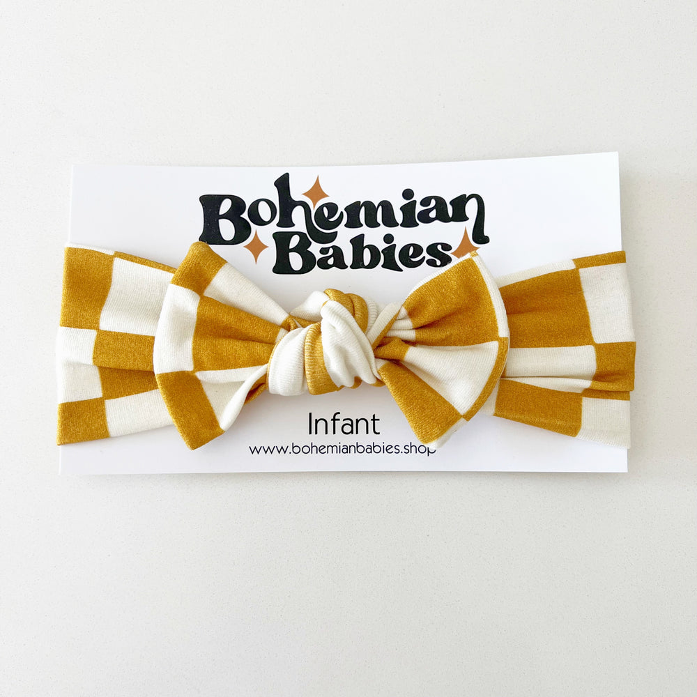 
            
                Load image into Gallery viewer, PREORDER - Golden Spice Checkered Organic Bow Headband - BohemianBabies
            
        